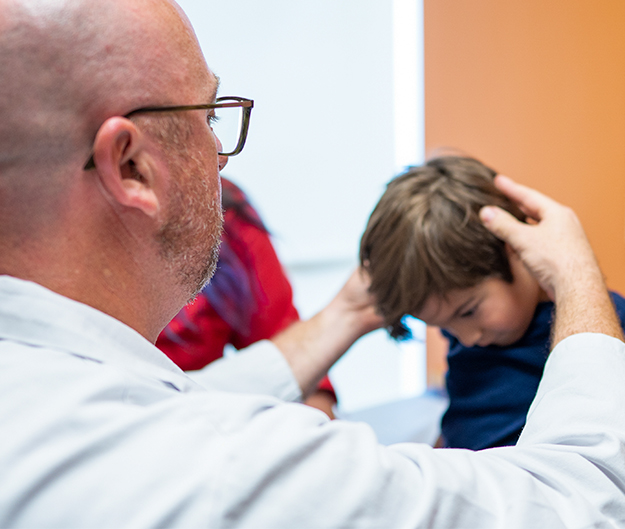 Dean Hertzler, MD, Chief, Pediatric Neurosurgery, with Shane, who had craniosysnostosis and craniofacial surgery