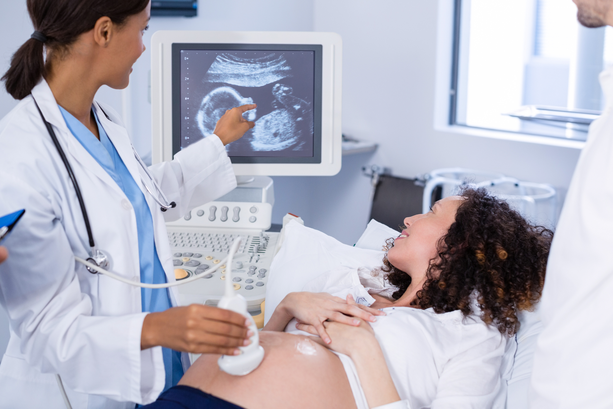 woman receiving pregnancy ultrasound